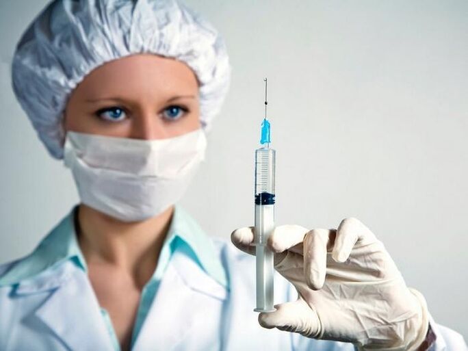 syringe with vaccine and drink alcohol